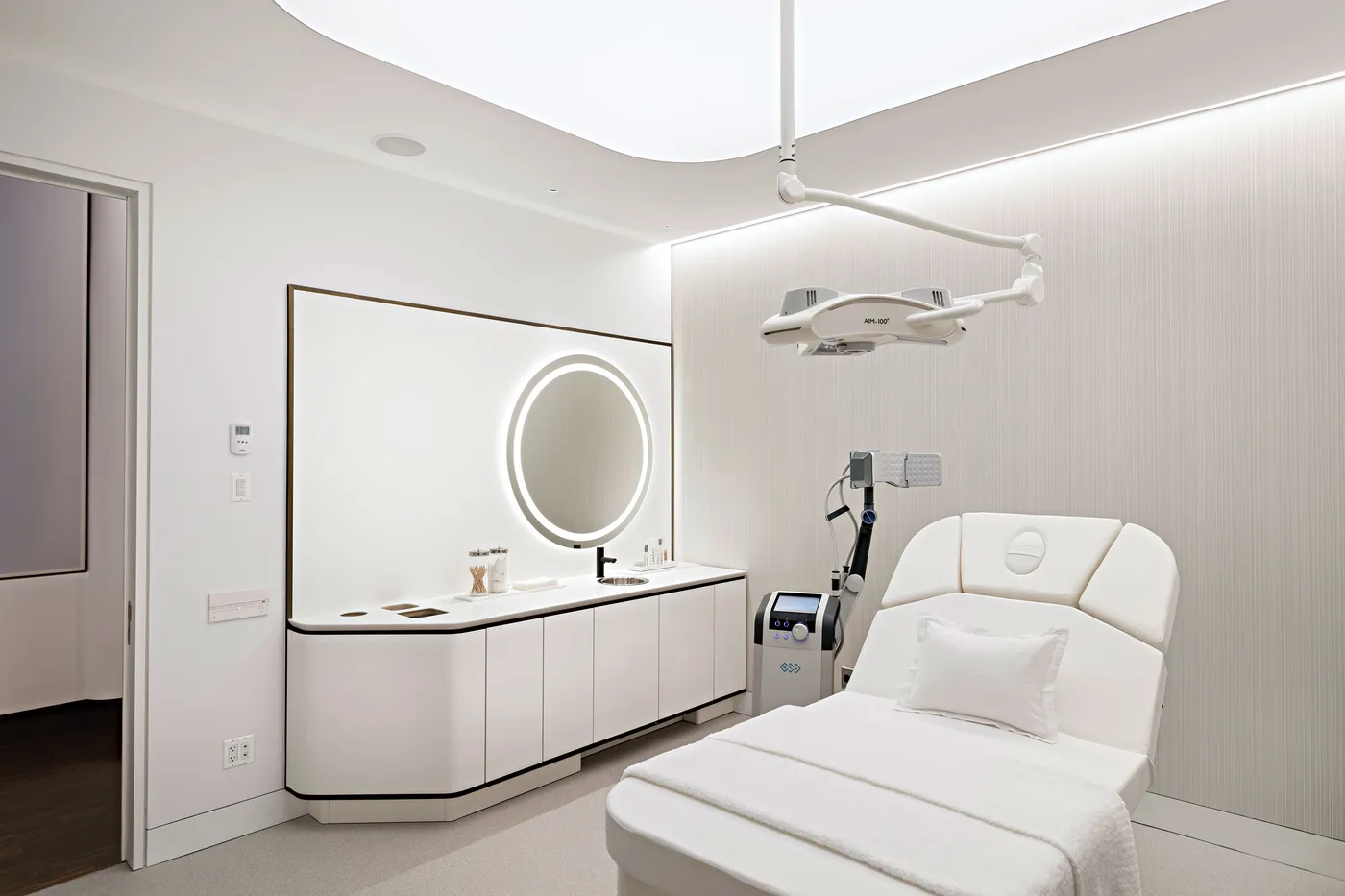 Plastic surgeon talking a patient through her consultation across his desk